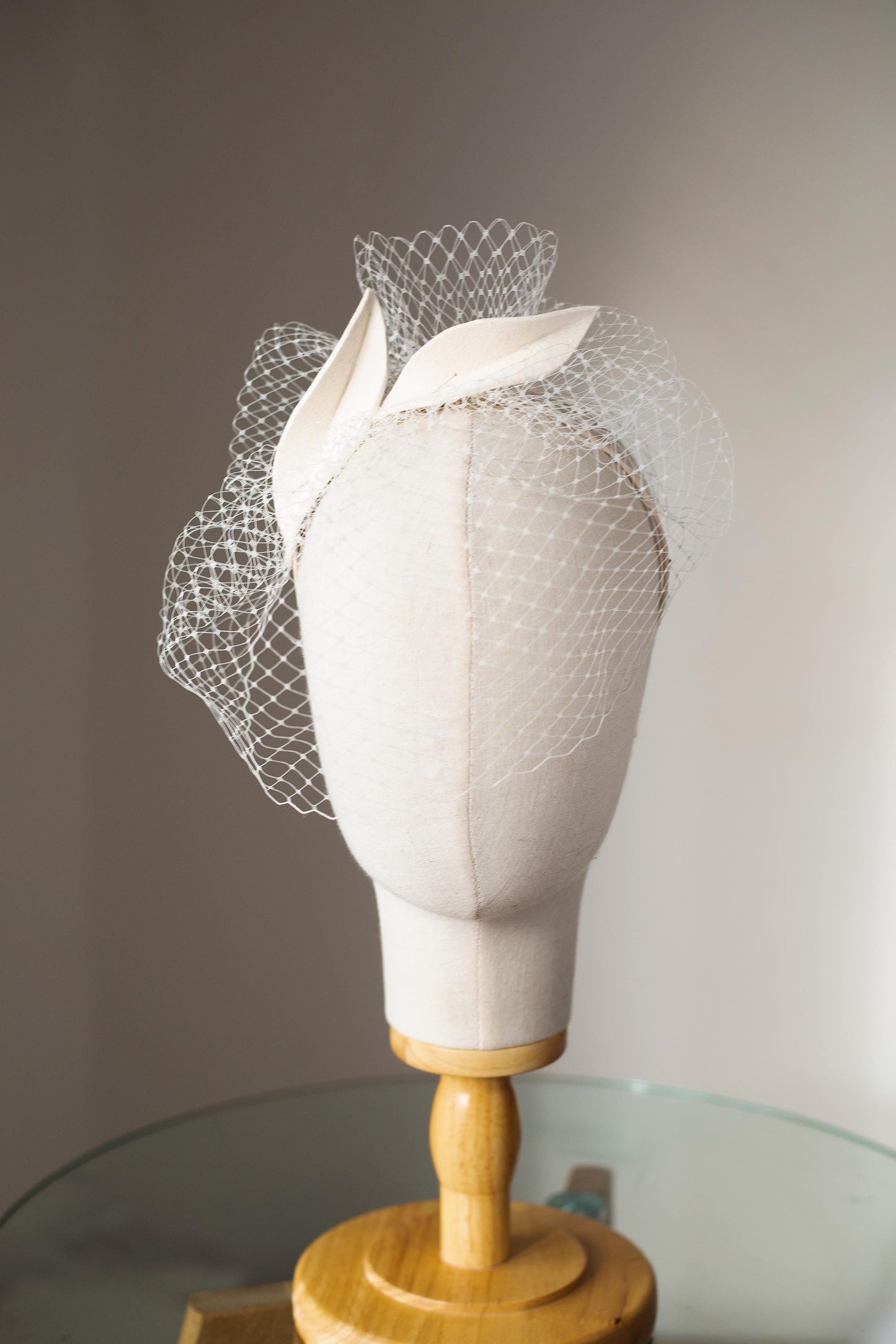 Bridal petals fascinator with short birdcage veil on beige skinny headband, ivory felt leaves head piece on netting veil