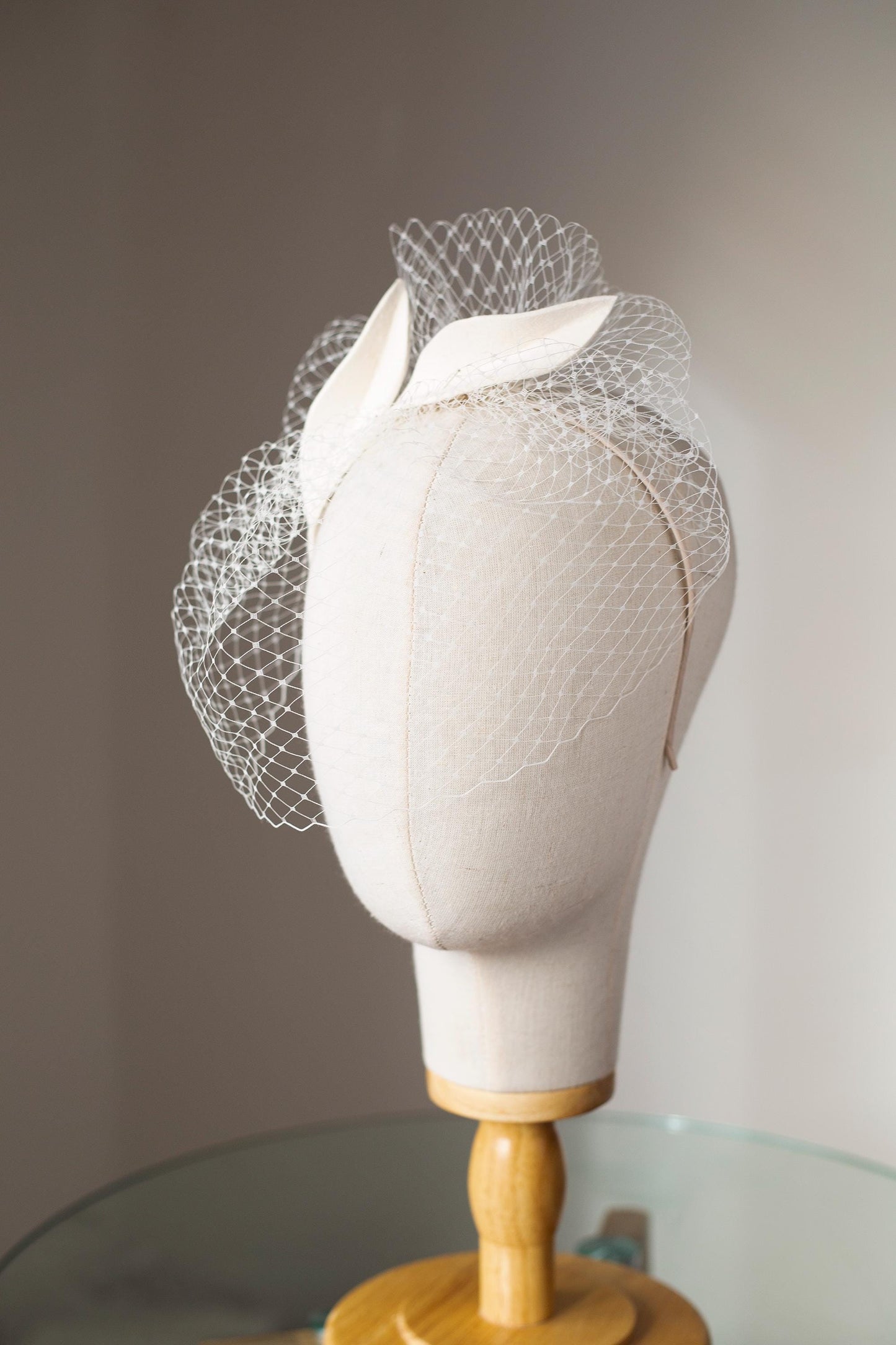 Bridal petals fascinator with short birdcage veil on beige skinny headband, ivory felt leaves head piece on netting veil