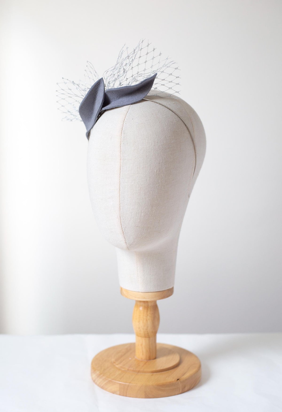 Steel Grey Leaf Fascinator: Metallic Silver Veiling Headpiece with netting accent