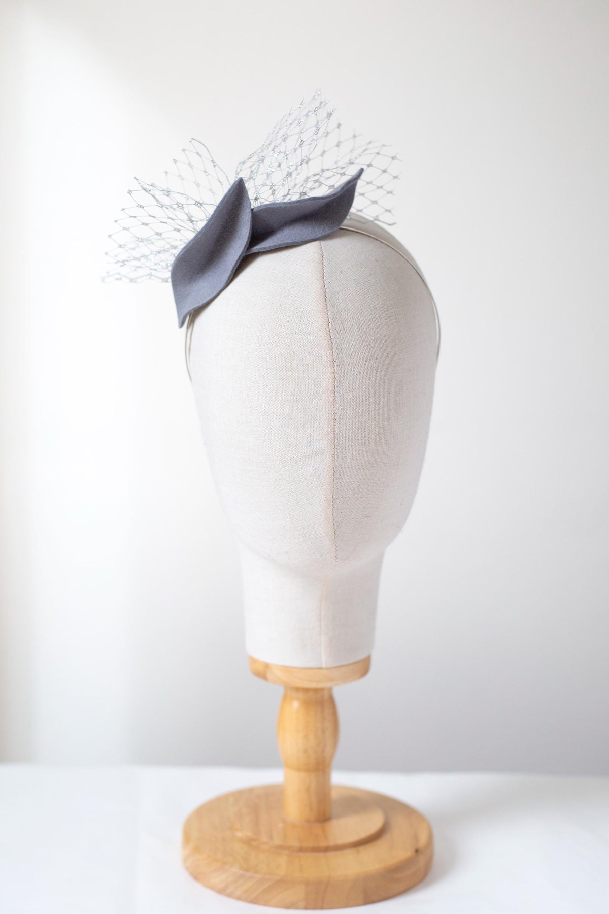 Steel Grey Leaf Fascinator: Metallic Silver Veiling Headpiece with netting accent