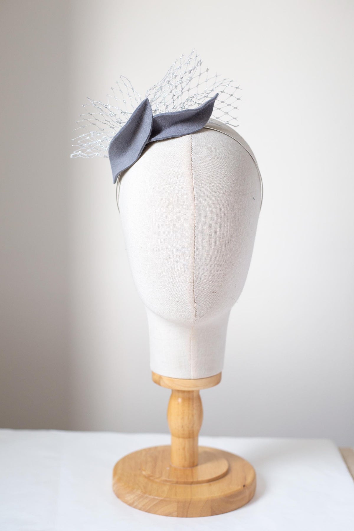 Steel Grey Leaf Fascinator: Metallic Silver Veiling Headpiece with netting accent
