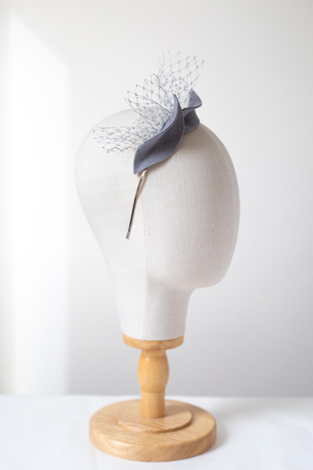 Steel Grey Leaf Fascinator: Metallic Silver Veiling Headpiece with netting accent